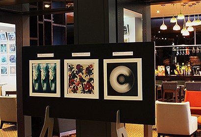 white frames for vinyl records mounted on a free standing display easel in a hotel reception